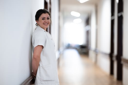 A tired nurse takes a quiet moment to rest in the hospital hallway, reflecting on a long and demanding shift. photo