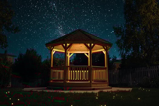 A gazebo lit up at night with stars in the sky photo