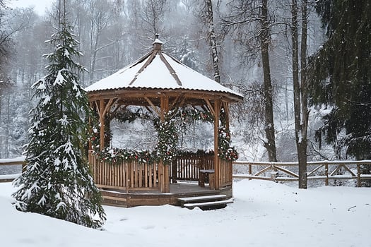 A gazebo surrounded by snow in a park photo