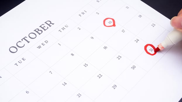 Red circle marked on a calendar at 10 and 31 of October as symbol of important day photo