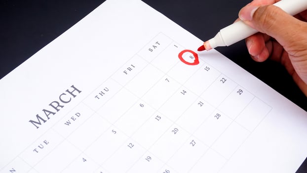 Red circle marked on a calendar at 8 of March as symbol of important day photo