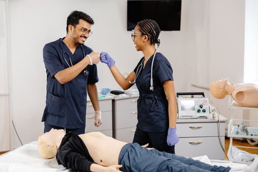 Medical Students Practicing CPR Training with Defibrillator and Mannequin photo
