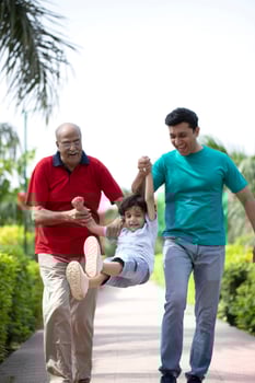 Father Grandfather Holding Hands And Swinging Small Boy photo