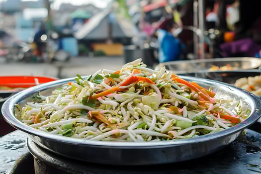 Delicious Stir-fried Bean Sprouts with Carrots and Herbs at a Busy Market. photo