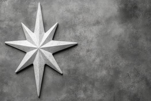 Carved White Star Symbol on a Textured Gray Stone Surface photo
