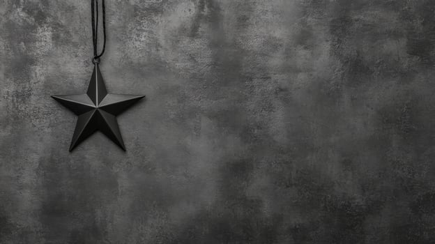 Black Star Pendant Hanging Against a Textured Dark Gray Surface photo