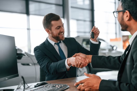 Successful ,deal. Two businessmen are working together in the car showroom photo