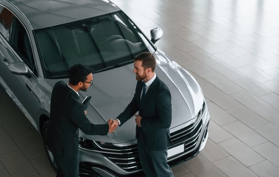 Top view. Man is consulting the customer,in the car showroom photo