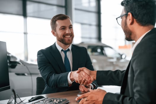 Successful ,deal. .Two businessmen are working together in the car showroom photo
