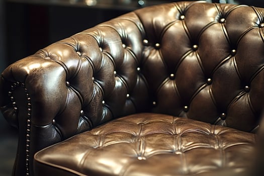 Luxurious brown leather chesterfield sofa exhibiting classic design photo