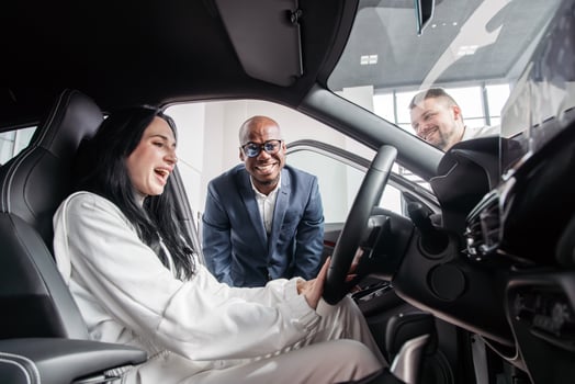 Dynamic interaction showcasing a car dealership effective communication and sales skills in promoting vehicle features to potential clients in a bright and inviting showroom photo