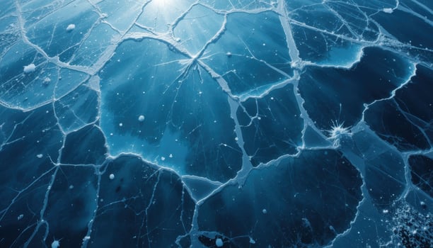 close up of the cracked ice background with a bluish gray tint and transparent areas. The network of cracks creates a unique pattern that highlights the frosty beauty of winter nature. photo