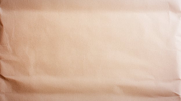 Wrinkled Brown Kraft Paper Texture with natural creases and folds, ideal for background or packaging design purposes. photo