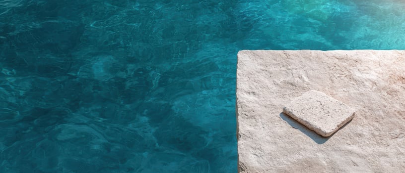 Tranquil turquoise water meets a stone platform on a sunny day photo