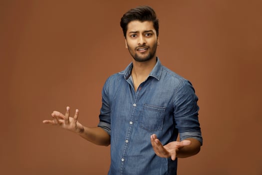 Indian model is making a shrug gesture. photo
