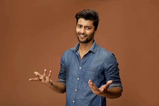 Handsome male model making a shrug gesture pose photo
