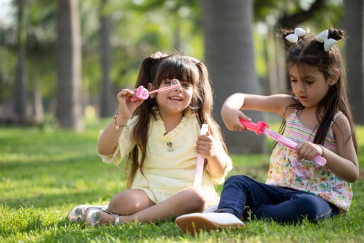 Two Little Girls Playing Bubble Wand Stick photo