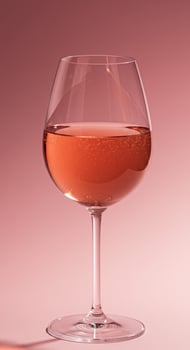 Elegant glass of rose wine, perfectly chilled, set against a serene pink background. photo