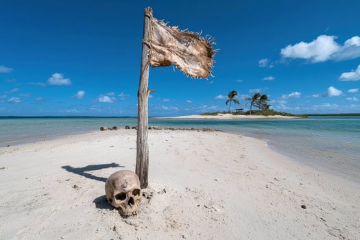Skull and tattered flag on a tropical island beach photo