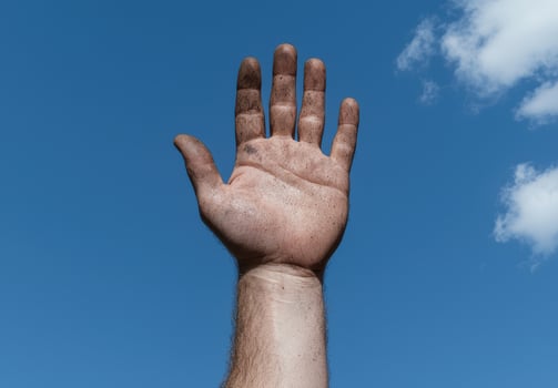 A dirty hand reaching towards the sky photo