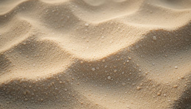 a close up of sand with water droplets on it photo