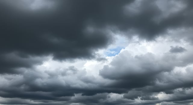 Storm clouds gather in a dramatic sky, creating a breathtaking cloudscape. photo