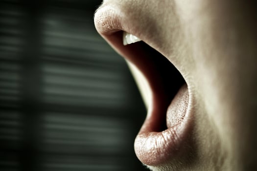 A person with their mouth open and their tongue out photo