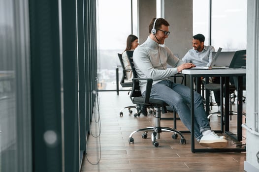 Everyone, is ,using laptop. Men and woman are working in the office together photo