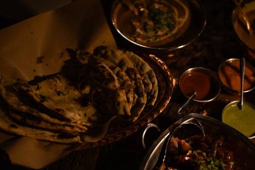 Indian dishes, tortillas and various sauces in plates on the table photo