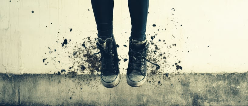 A person in black leggings and sneakers is jumping up and down photo