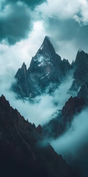 A mountain range with clouds and fog over it photo