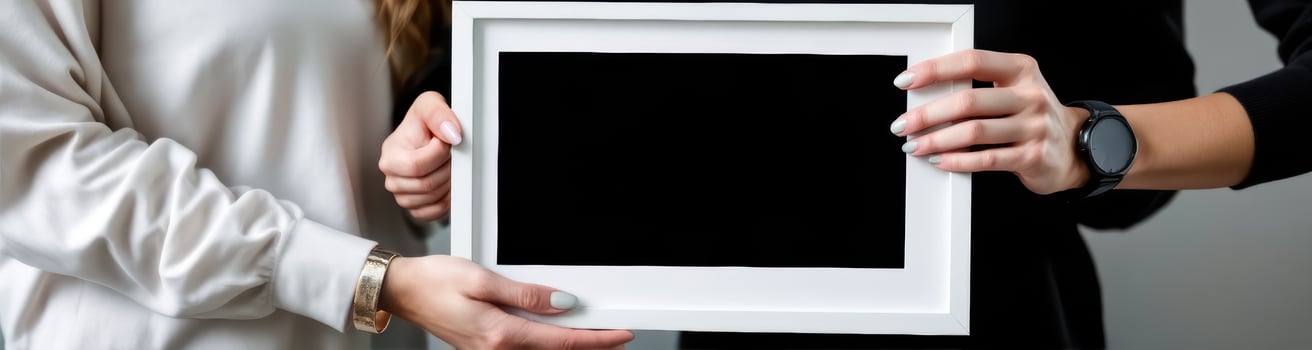 two hands presenting a blank frame photo