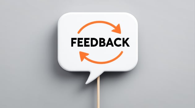 white speech bubble with circular arrows signifying feedback photo