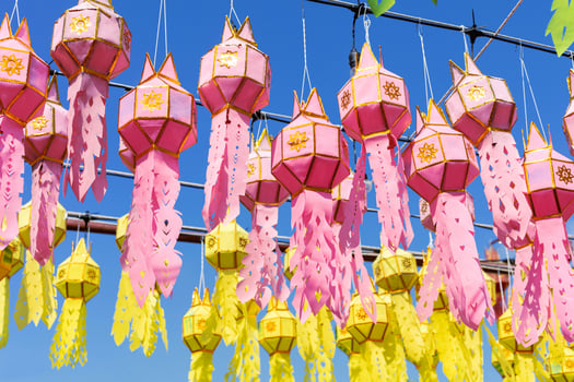 pink and yellow hanging lanterns lighting in loy krathong and new year festival at northern of thailand photo