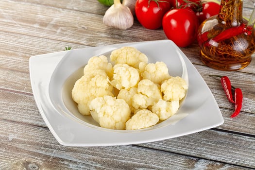 A white plate with cauliflower and other vegetables photo