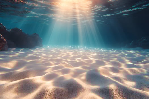 Underwater Serenity Sunlit Ocean Floor with Rippling Sand for Tranquil Design photo