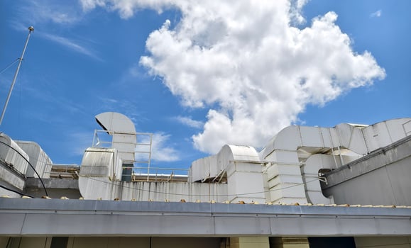 Ventilation pipes on the top of large industrial building photo