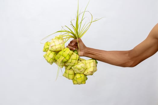 Freshly Made Ketupat held by hand, Traditional Dish for Festive Occasions photo