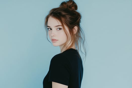 A young woman with a messy bun in her hair photo