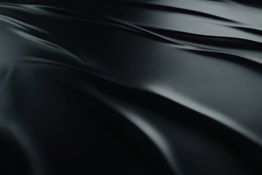Dark, flowing fabric drapes. Detailed close-up of smooth, luxurious folds photo