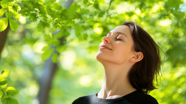 A woman is looking up at the sky while breathing deeply photo