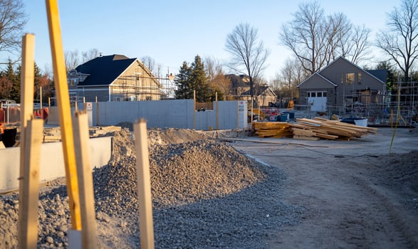 A construction site with a pile of gravel and a yellow pole photo