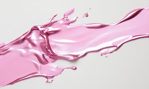 A pink liquid splashing on a white surface photo