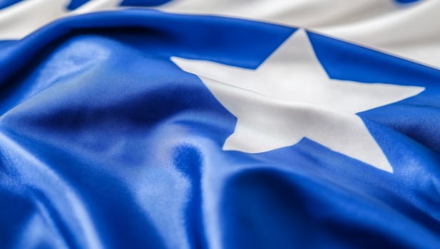 Close-up of a blue and white flag featuring a star design. photo
