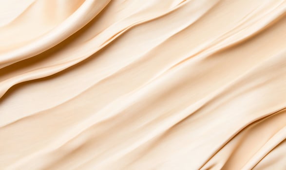 Smooth, flowing fabric texture in soft beige tones. photo