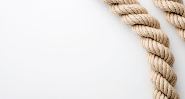 A close-up of twisted rope against a plain background. photo