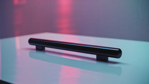 A black metal bar with a black handle sits on a white table photo