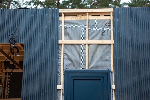 Partially Constructed House with Blue Cladding and Ventilation System photo