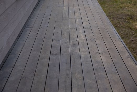 Wooden Deck with Horizontal Siding and Adjacent Grass Area photo