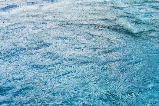 Fresh of the rain falling in calm blue sea surface with feeling of relaxation and peace in tropical natural seasonal photo